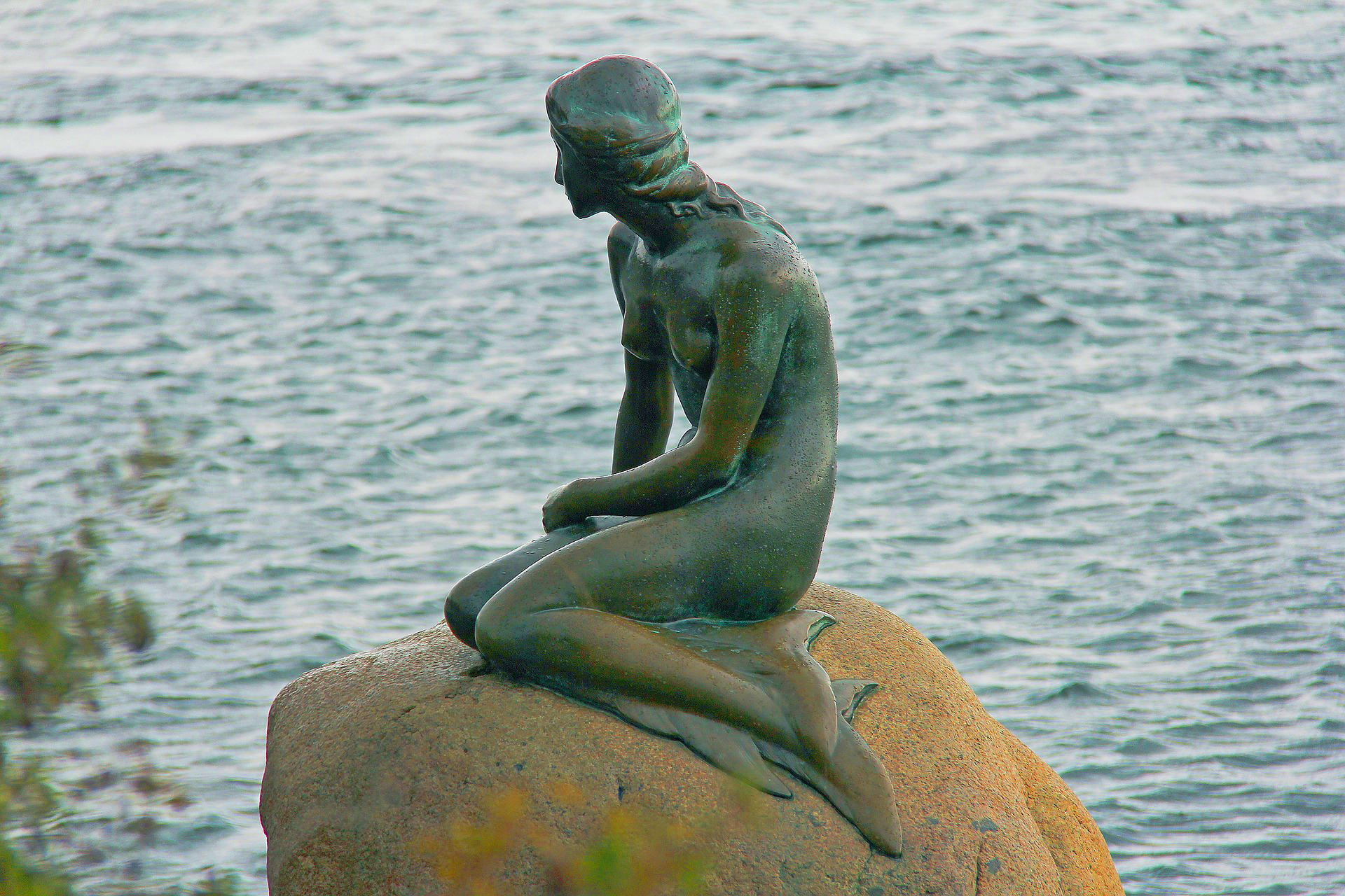 A bronze statue of The Little Mermaid in Denmark.