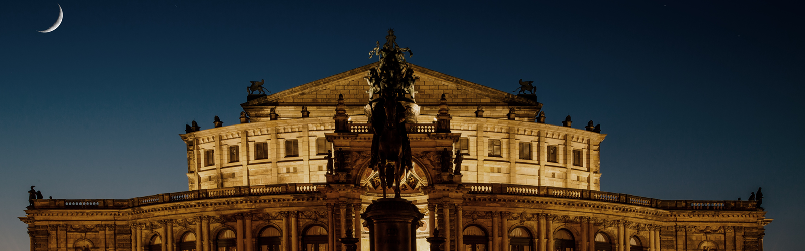 This image shows the Semperoper opera house in Dresden, Germany, famously illuminated at night.