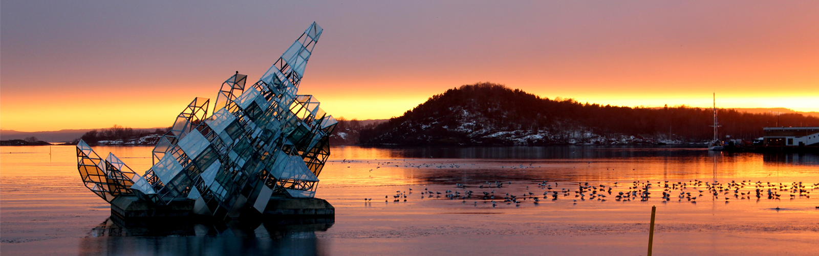A photo of a sculpture in a lake in Norway.