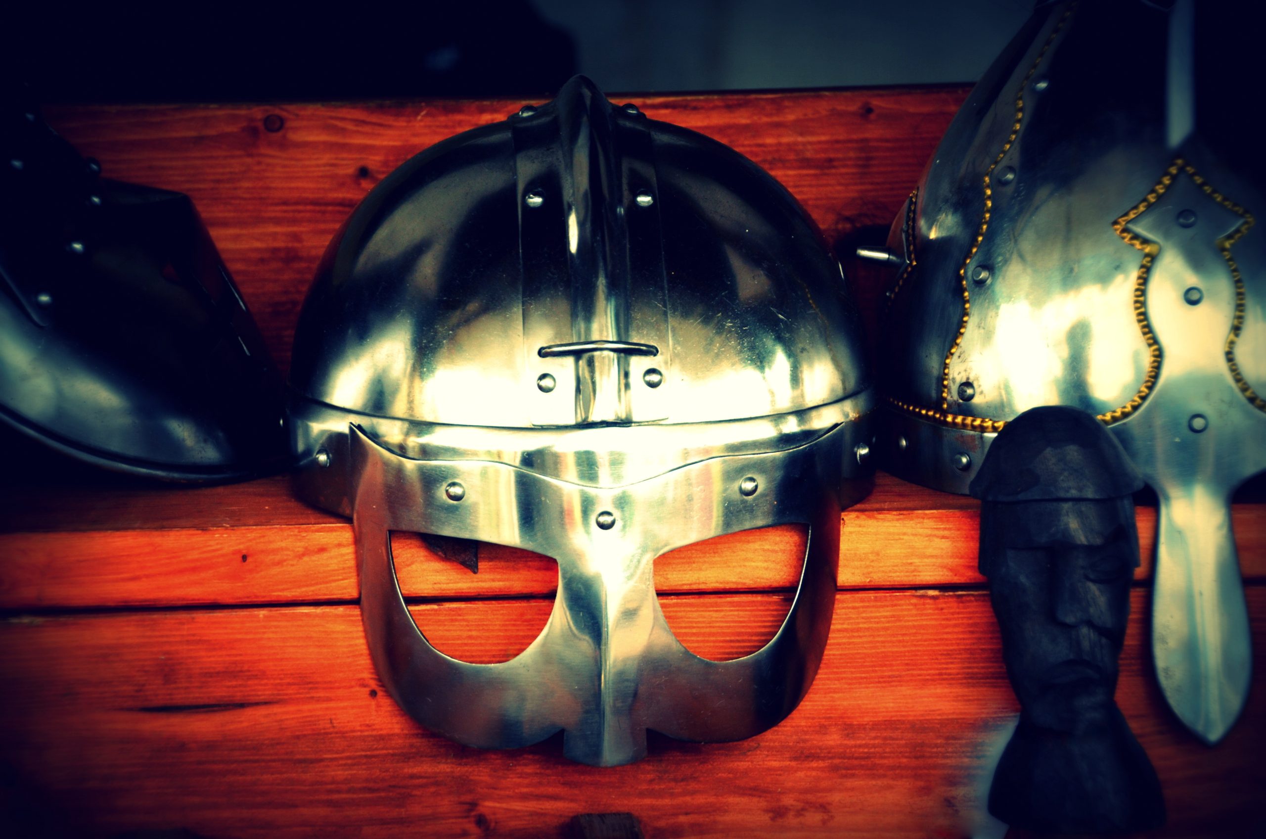 A photo of nordic helmets on wooden steps. 