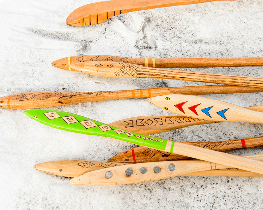 These are hand-carved wooden "snow snakes" used in traditional Ojibwe winter games.