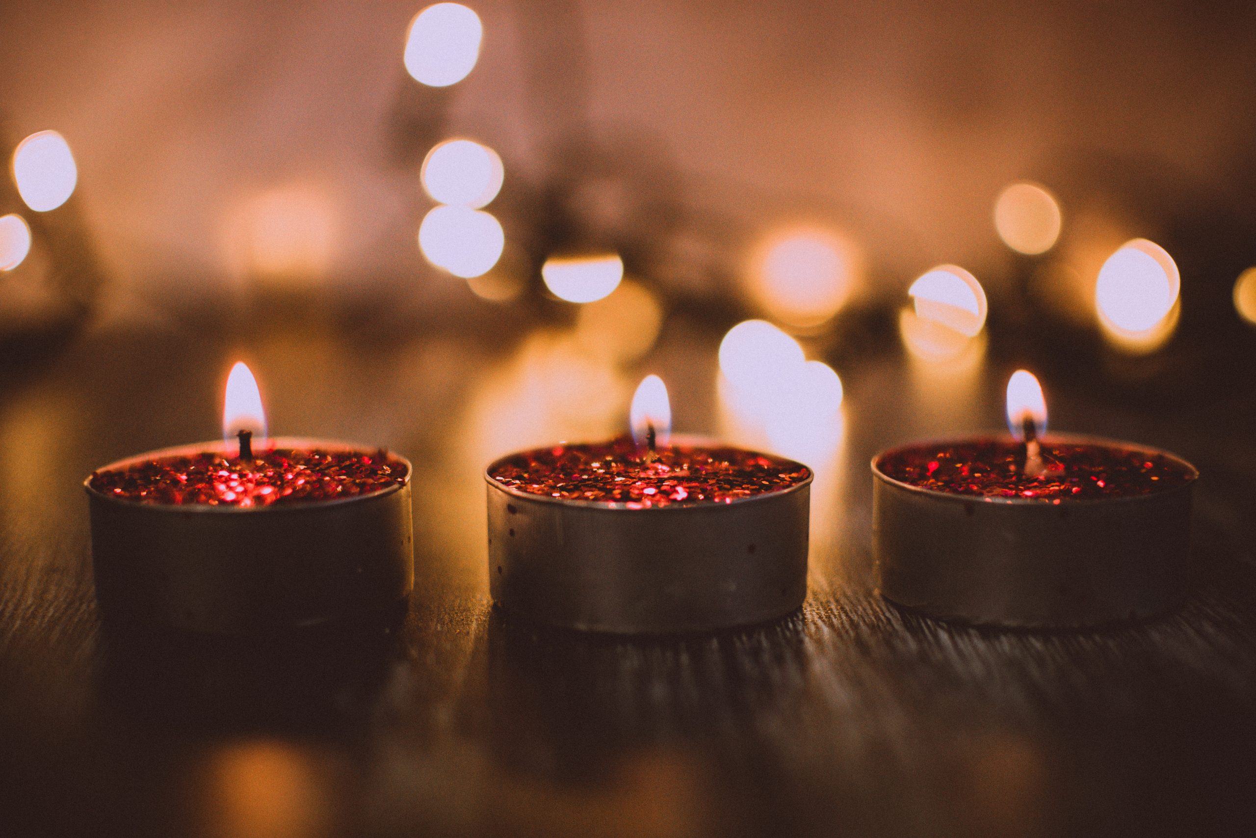 A photo of three candles. They are lit.