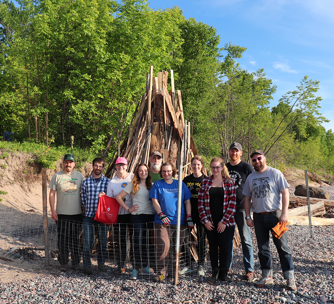 This image shows a kokko, a traditional Finnish bonfire built by volunteers for the Juhannus (Midsummer) festival.