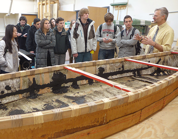 GNS+ Professor and Department Chair Thomas A. DuBois shows a Birchbark Canoe to Students
