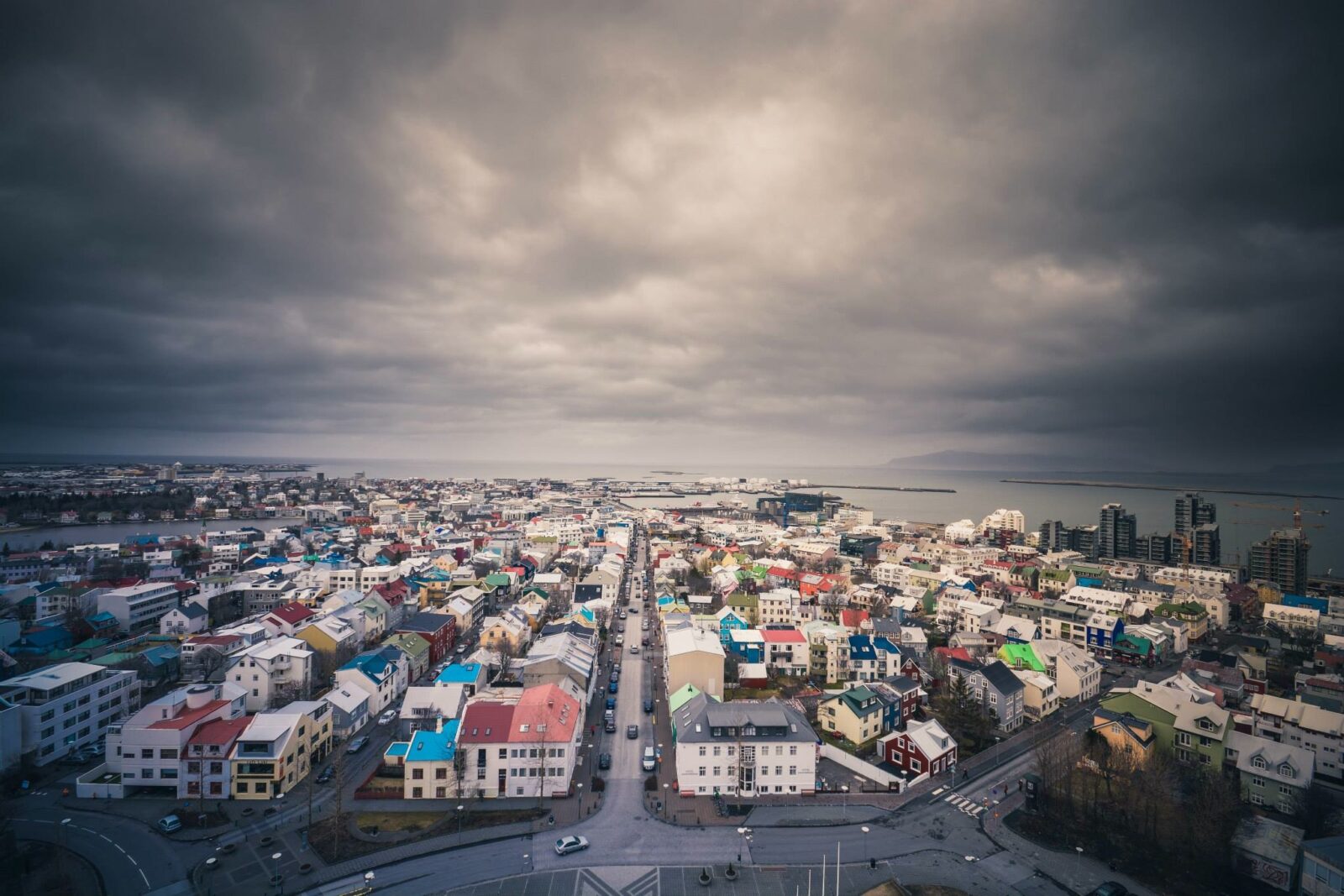A photo of an Icelandic city under stormy clouds. 