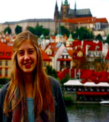 image of study abroad alumna Emma Miller standing on the Charles Bridge in Prague.