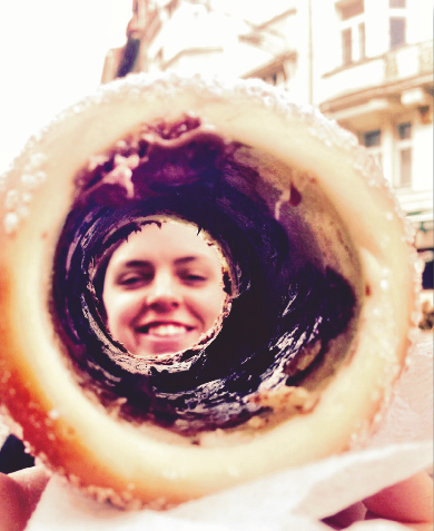 image of study abroad alumna Ella Jankoski, creatively seen through the inside of the Czech delicacy "trdelnik".