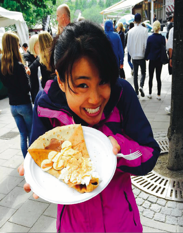 image of study abroad alumna Eva Shelton preparing to enjoy a Swedish treat.