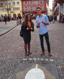 image of study abroad alum Sascha Glaeser, right, in front of the "Rathaus" Town Hall, and noting Madison's sister city status with Freiburg.