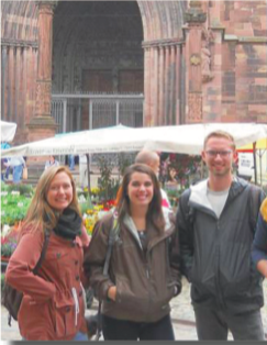 image of study abroad alumna Emily Laurence (middle) and fellow AYFers in front of the Freiburg Münster
