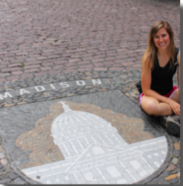 image of study abroad alumna Kate Schwen sitting next to a picture of Madison in the middle of Freiburg.