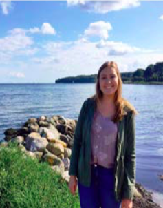 image of study abroad alumna Taylor Raether enjoying a food festival by the ocean featuring lots of traditional Danish food in Aarhus, Denmark.