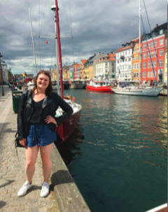 image of study abroad alumna Sydney Krassen in front of Copenhagen's famous canal, Nyhavn, one of her favorite spots in the city.