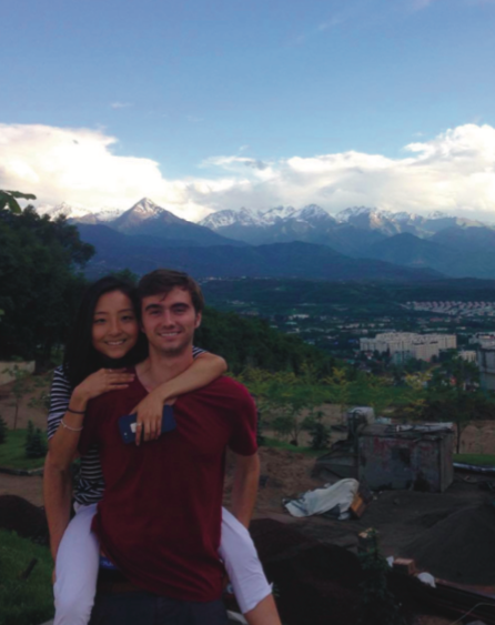 image of study abroad alumna Yuka Shiotani (left) and friend with the mountains of Almaty in the background.