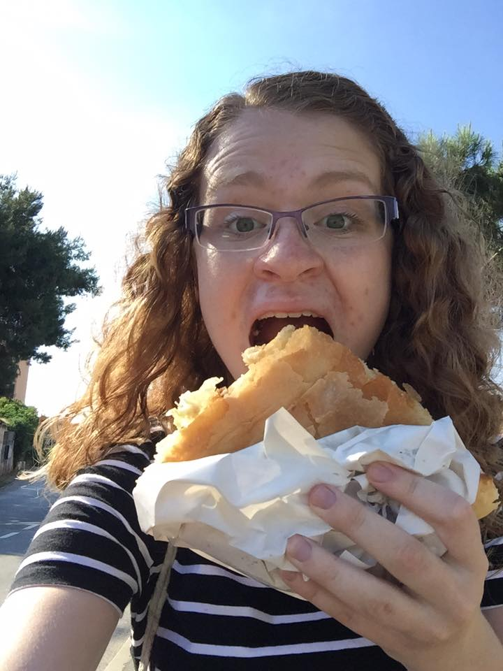 image of study abroad alumna Noelle Stadler eating a delicious piece of Burek in Croatia